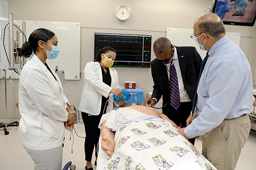 Heather Duplessis and Lauren Bagneris with LSU President William F. Tate IV in simulation education scenario